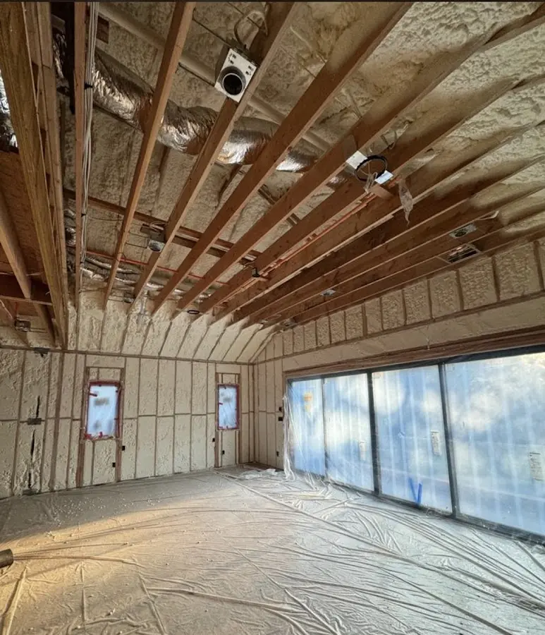 Interior walls and ceiling insulated with spray foam during new construction in Orosi